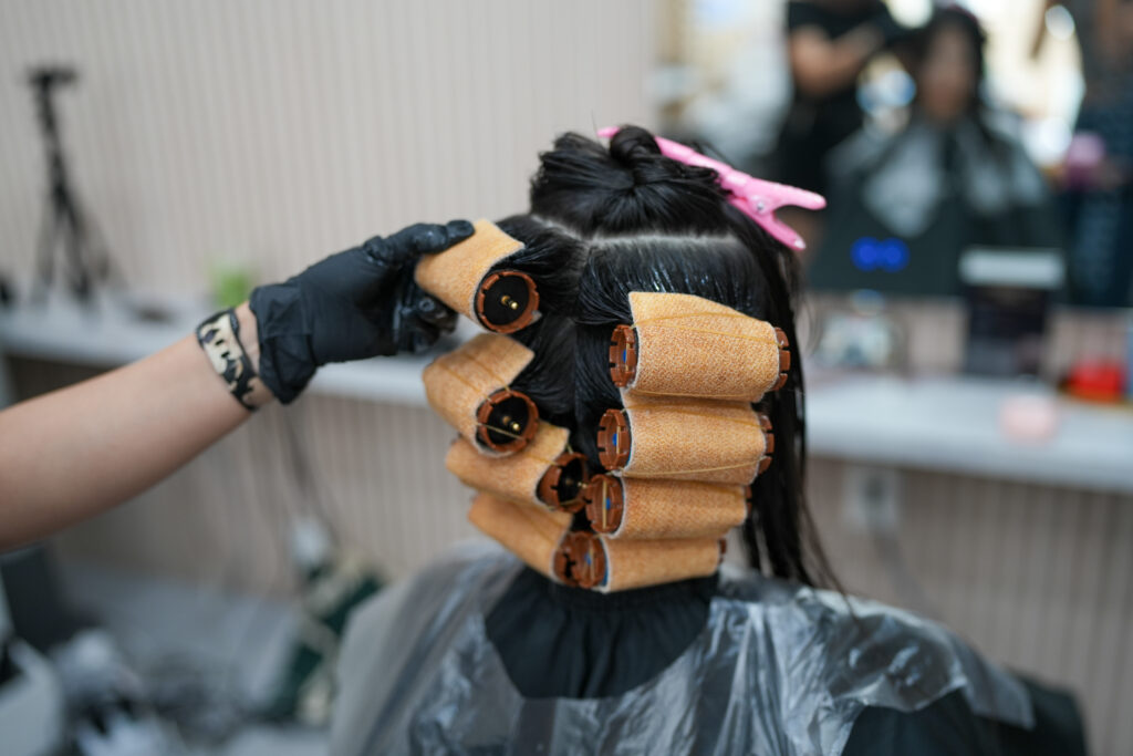 Applying digital perm rollers at PERFECT X HAIR